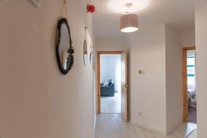 a hallway with a mirror on a wall at City Centre Riverview Apartment in Derry Londonderry