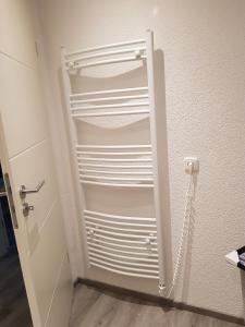 a white closet with a door open in a room at Lila Pause in Ellweiler