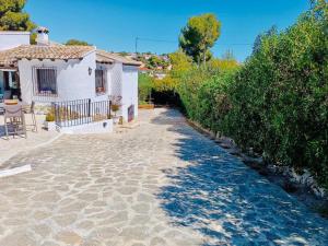 a house with a pathway leading to a house at 1-Bed Apartment close to Moraira town centre in Moraira