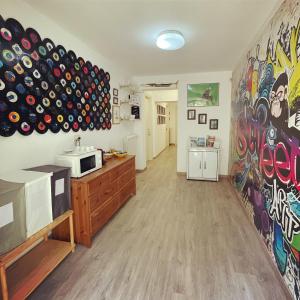 a room with a kitchen with a wall covered in graffiti at 211 Underground in Viareggio