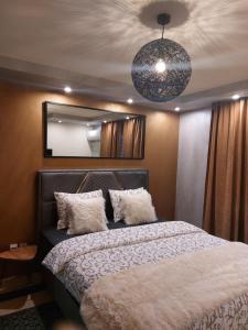 a bedroom with a large bed and a mirror at Elite-stan na dan in Berane