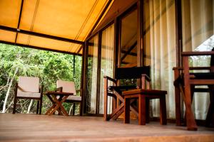 a group of chairs sitting on a porch at Wild Trails Yala by Suri in Yala