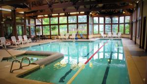 a large swimming pool with chairs in a building at Crystal Mountain in Thompsonville