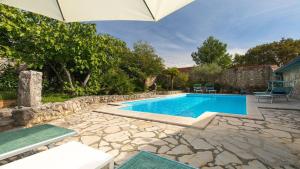 a swimming pool in a yard with an umbrella at Villa Rosemary in Bajčići