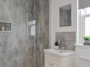 a bathroom with a shower and a sink at Keyland Cottage in Johnshaven