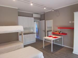 a small room with a bed and a desk in it at B&B Vinago Belvedere in Mornago