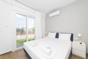 Postel nebo postele na pokoji v ubytování Aphrodite Residential Complex