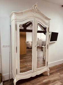 a white cabinet with a mirror in a room at Studio 3 du SPA Célinie in Warcq