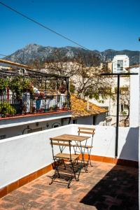 einen Tisch und Stühle auf einem Gebäude in der Unterkunft Bermeja Village in Marbella