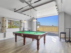 a billiard room with a pool table in it at Rose Cottage in Muff