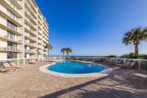 a swimming pool in front of a building at Seaside Beach & Racquet 2105 in Orange Beach