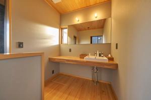 a bathroom with a sink and a mirror at YHouse in Kumamoto