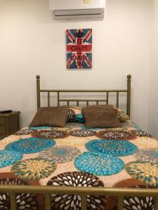 a bed with a quilt on it in a bedroom at Martinica Hostel in Cartagena de Indias