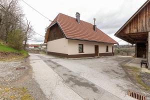 a building with a brown roof on a road at Počitniška Hiša Pr Martinovih in Postojna