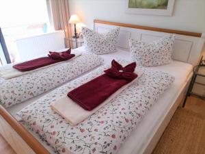 2 Betten mit Handtüchern und Bögen darauf in der Unterkunft Waldoase I inkl Sauna-und Schwimmbadnutzung in Bad Harzburg