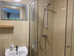 a bathroom with a shower and a sink at Budget Rooms in Inverness