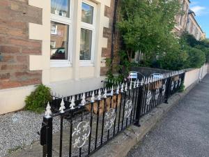 a black wrought iron fence in front of a building at Budget Rooms in Inverness