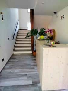 a hallway with a staircase with a counter and flowers at Agritur Lavanda in Nave San Rocco
