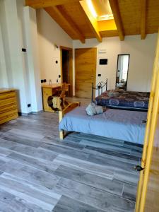 a bedroom with two beds and a wooden ceiling at Agritur Lavanda in Nave San Rocco