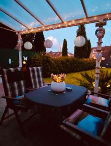 a table and chairs on a patio with lights at Apartment Glesch in Bergheim