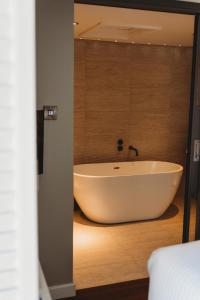 a bathroom with a bath tub in a room at Finch's Arms in Oakham +31 photos