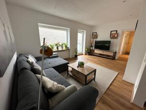 a living room with a couch and a table at Traunkai Apartments Bad Ischl in Bad Ischl