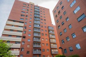 two tall brick buildings next to each other at For Your Rentals Amplio y luminoso apartamento en Orcasitas - Wifi BEA25 in Madrid