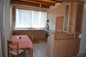 a kitchen with a table and a small table and chairs at Anastasia Apartment in Zakynthos