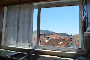 a kitchen window with a view of a city at Anastasia Apartment in Zakynthos