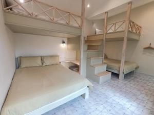 a bedroom with a bed and two bunk beds at Aob-Oun Homestay in Pak Chong