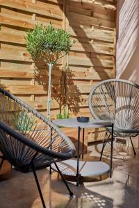 two chairs and a table on a patio at Beautiful City Center Apartment in Zakynthos Town