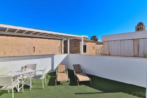 eine Terrasse mit einem Tisch und Stühlen auf dem Dach in der Unterkunft Casa Jaume II 262 By Mallorca Charme in Muro
