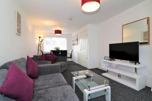 a living room with a couch and a tv at Signature - Atholl House Glasgow Airport in Paisley