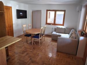 a living room with a table and a couch at Halász Vendégház Tiszakécske in Tiszakécske