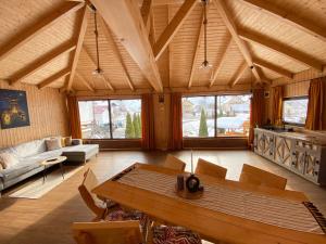 a living room with a table and a couch at Casa Violetei in Bran