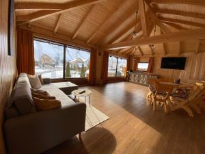 a living room with a couch and a table at Casa Violetei in Bran