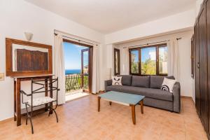 a living room with a couch and a table at Villa Vista Mare in Kalkan