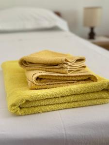a stack of towels sitting on top of a bed at Casa Agnese Monterosso al mare in Monterosso al Mare