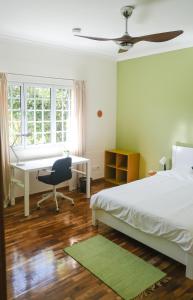 a bedroom with a bed and a desk and a computer at LAVA Açores Coliving & Coworking in Ribeira Grande