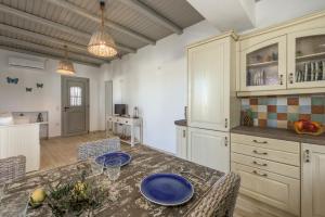 a kitchen with a table with blue plates on it at Happy Babi in Adamantas +14 photos