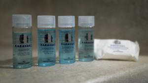 three bottles of water sitting on a table with a bag at Happy Babi in Adamantas
