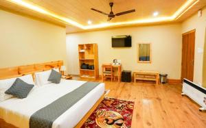 a bedroom with a bed and a flat screen tv at Shomo Chuki Resort in Paro