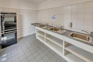 uma cozinha com 2 lavatórios e um forno em StroamCamp Schwedt em Schwedt