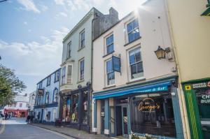 a group of buildings on a city street at Tipyn O Haul - 1 Bedroom Apartment - Tenby in Tenby