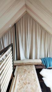 a room with a bed in a tent at Maison Aux portes d'Emparis in Mizoën