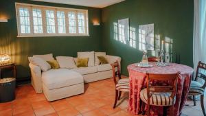 a living room with a couch and a table at Cottage auf idyllischem Landsitz mit Parkanlage in Negernbötel +43 photos