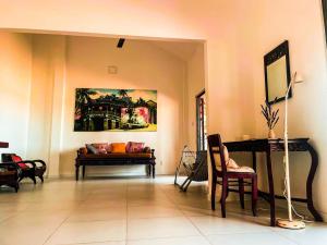 a living room with a couch and a piano at orange house in Tam Kỳ