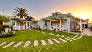 a house with a green lawn in front of it at Brigadoon Boutique Guesthouse in Swakopmund