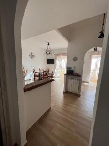 a kitchen and living room with a wooden floor at Waikiki House in Passoscuro