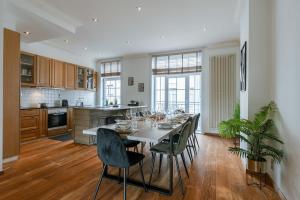 a kitchen and dining room with a table and chairs at Beautiful and spacious vacation home 'Villa Willy' in Blankenberge